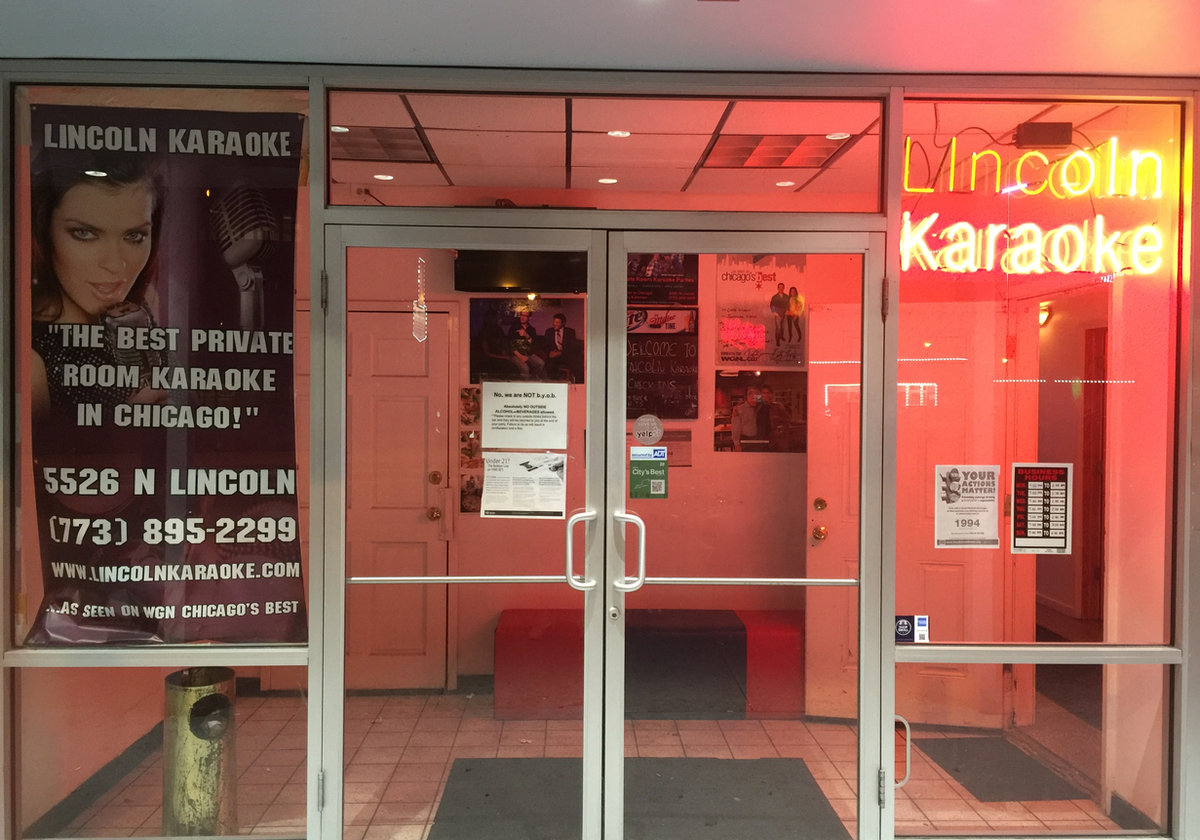 Lincoln Karaoke storefront at night with neon sign
